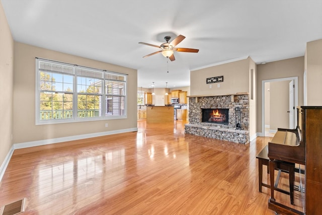 3337 Tarsus Rd, Palmyra, TN 37142 - unfurnished living room featuring a ceiling fan, a fireplace, and light wood-type flooring
