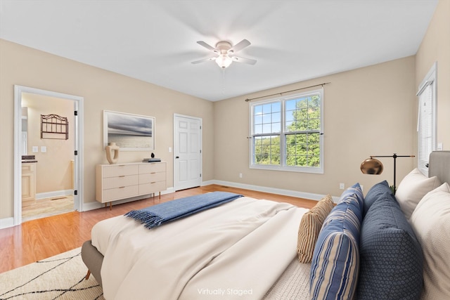 3337 Tarsus Rd, Palmyra, TN 37142 - bedroom with light wood-type flooring, connected bathroom, and ceiling fan