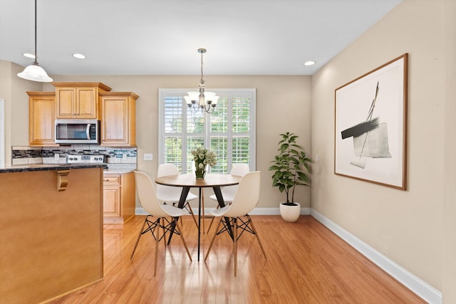 3337 Tarsus Rd, Palmyra, TN 37142 - kitchen featuring stainless steel microwave, light wood-style flooring, backsplash, a chandelier, and recessed lighting
