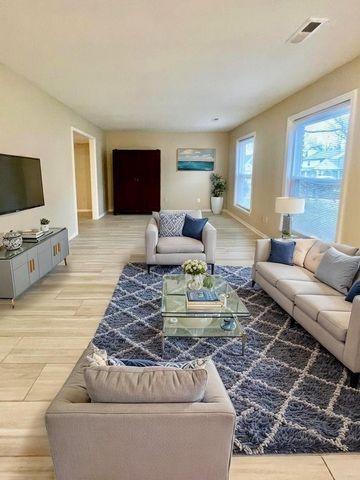 living area featuring light wood-type flooring and baseboards