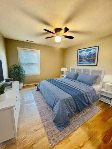 bedroom with light wood-type flooring and ceiling fan