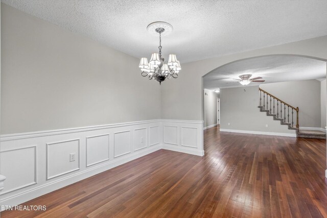 122 Springfield Ln, Jacksboro, TN 37757 - empty room with arched walkways, ceiling fan, dark wood finished floors, a chandelier, and stairs