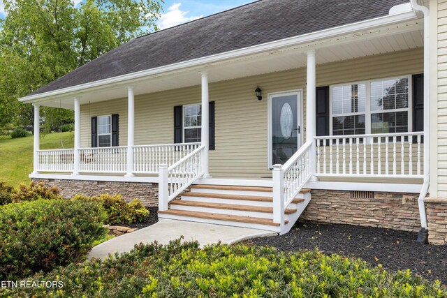 122 Springfield Ln, Jacksboro, TN 37757 - doorway to property featuring a shingled roof and covered porch
