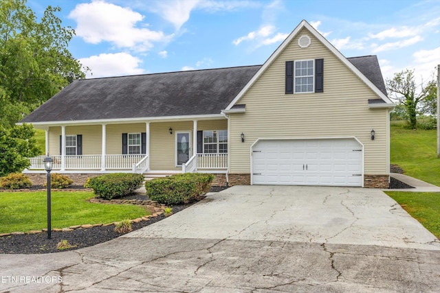 122 Springfield Ln, Jacksboro, TN 37757 - view of front of home featuring concrete driveway, a porch, a front lawn, a garage, and roof with shingles