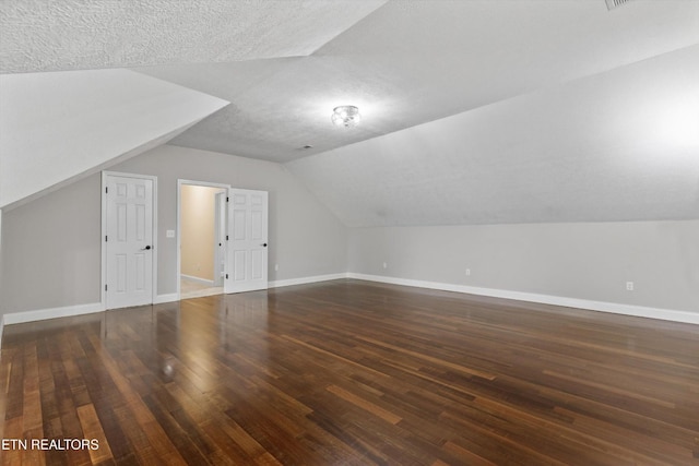 122 Springfield Ln, Jacksboro, TN 37757 - additional living space featuring vaulted ceiling, wood finished floors, a textured ceiling, and baseboards