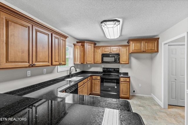 122 Springfield Ln, Jacksboro, TN 37757 - kitchen with black appliances, a sink, brown cabinetry, dark stone countertops, and a textured ceiling