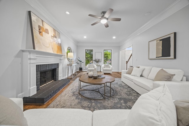 1183 Buckingham Cir, Franklin, TN 37064 - living room featuring a ceiling fan, wood finished floors, a fireplace, crown molding, and recessed lighting