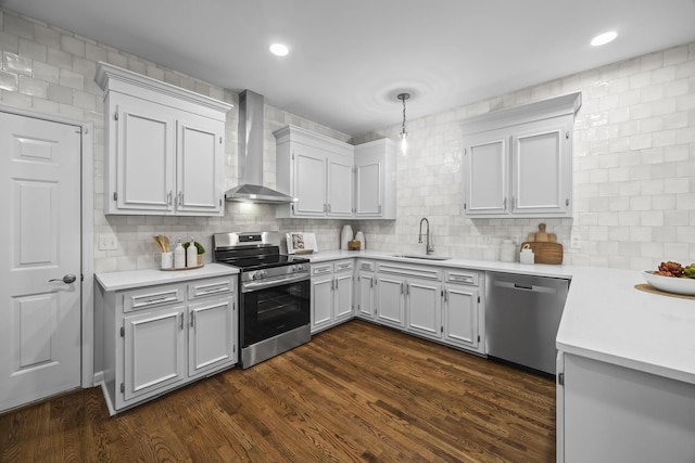 1183 Buckingham Cir, Franklin, TN 37064 - kitchen featuring appliances with stainless steel finishes, wall chimney range hood, a sink, light countertops, and decorative backsplash