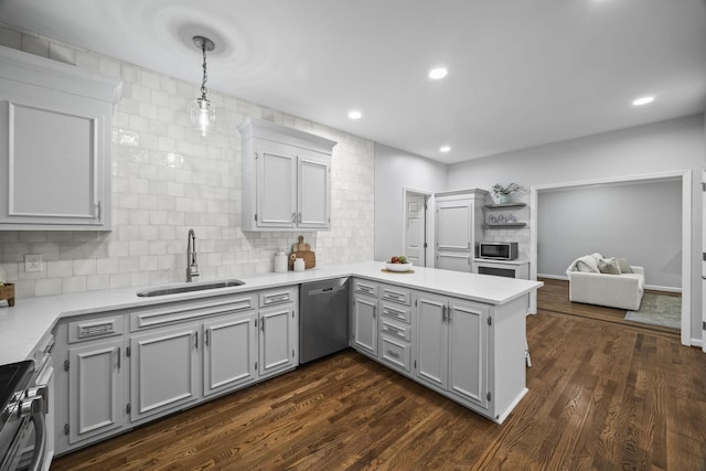 1183 Buckingham Cir, Franklin, TN 37064 - kitchen featuring appliances with stainless steel finishes, a sink, a peninsula, light countertops, and recessed lighting