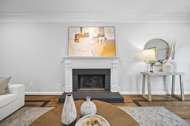 1183 Buckingham Cir, Franklin, TN 37064 - living room featuring crown molding, a brick fireplace, wood finished floors, and baseboards