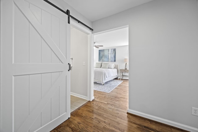 1183 Buckingham Cir, Franklin, TN 37064 - corridor featuring a barn door, dark wood-style floors, and baseboards