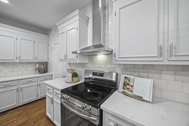 1183 Buckingham Cir, Franklin, TN 37064 - kitchen featuring wall chimney range hood, stainless steel electric range, white cabinets, decorative backsplash, and dark wood finished floors