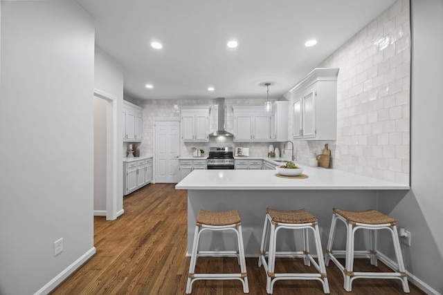 1183 Buckingham Cir, Franklin, TN 37064 - kitchen featuring stainless steel electric stove, a sink, decorative backsplash, light countertops, and a peninsula