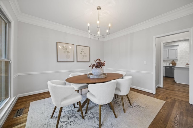 1183 Buckingham Cir, Franklin, TN 37064 - dining area with a chandelier, crown molding, wood finished floors, and baseboards