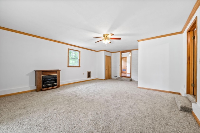 unfurnished living room featuring ornamental molding, a ceiling fan, baseboards, and carpet floors