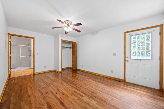 unfurnished bedroom with light wood finished floors, baseboards, and a ceiling fan