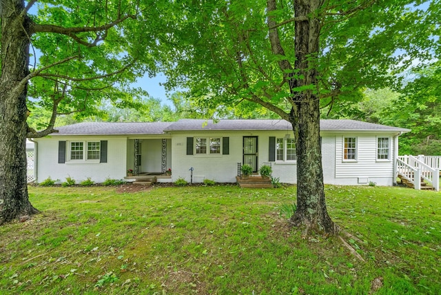 ranch-style home featuring a front yard