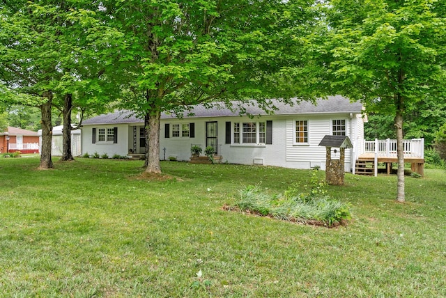 view of front of property with a wooden deck, a front yard, and a shingled roof