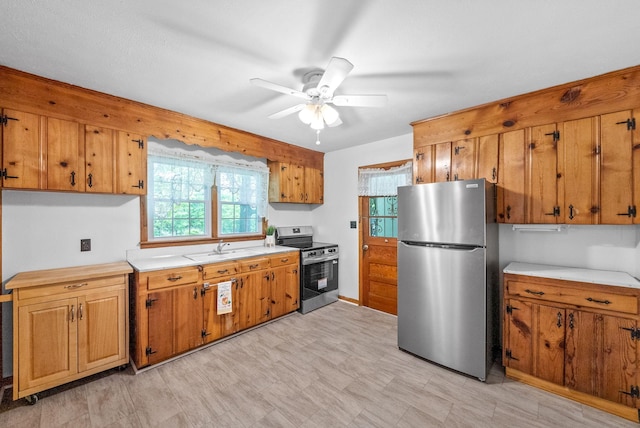 kitchen featuring stainless steel appliances, light countertops, and brown cabinetry