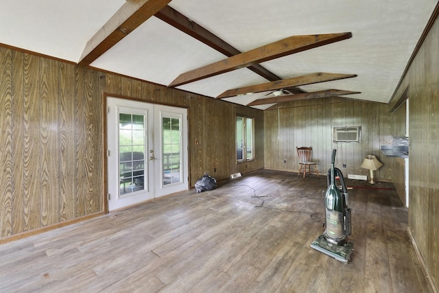 1023 Pine Valley Rd, Kingston Springs, TN 37082 - unfurnished living room with french doors, wood walls, wood finished floors, and an AC wall unit