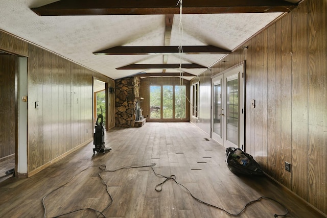 1023 Pine Valley Rd, Kingston Springs, TN 37082 - unfurnished living room featuring wooden walls, wood finished floors, and french doors