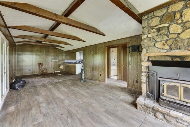 1023 Pine Valley Rd, Kingston Springs, TN 37082 - unfurnished living room with beamed ceiling, wooden walls, wood finished floors, a fireplace, and high vaulted ceiling