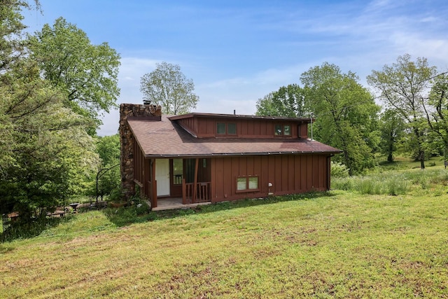 1023 Pine Valley Rd, Kingston Springs, TN 37082 - rear view of house with a chimney, a yard, and board and batten siding