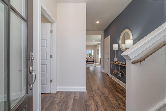 foyer entrance with dark wood-type flooring, recessed lighting, and baseboards