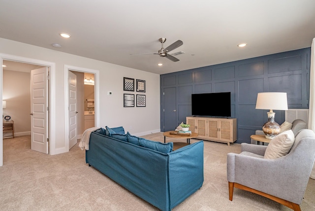 living room with light colored carpet, ceiling fan, recessed lighting, and baseboards
