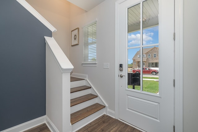 entryway featuring dark wood finished floors, stairway, and baseboards