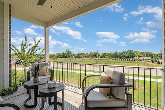 balcony with a ceiling fan and a rural view