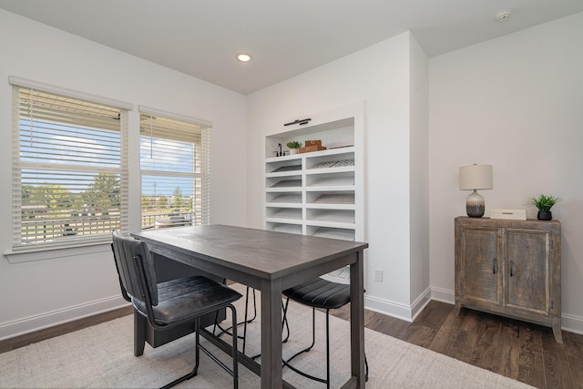 dining room featuring dark wood finished floors, baseboards, and recessed lighting