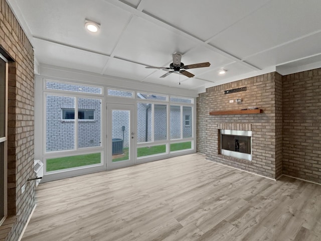 6332 York Dr, Hermitage, TN 37076 - unfurnished living room with a brick fireplace, wood finished floors, a ceiling fan, brick wall, and coffered ceiling