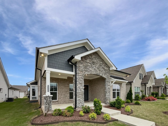 6332 York Dr, Hermitage, TN 37076 - view of front facade featuring central air condition unit, a front lawn, and stone siding