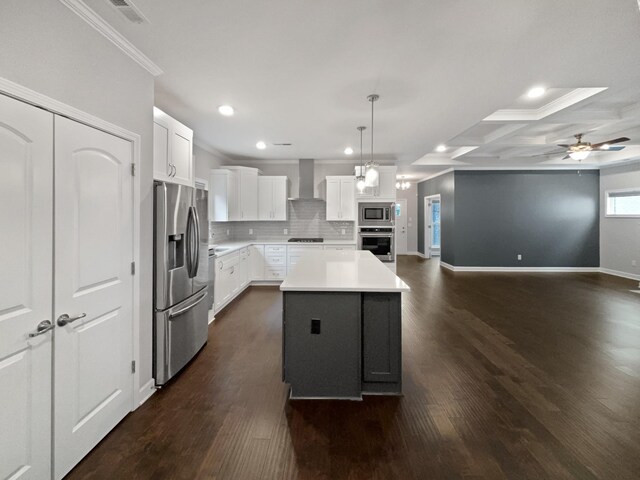 6332 York Dr, Hermitage, TN 37076 - kitchen with stainless steel appliances, wall chimney exhaust hood, a ceiling fan, dark wood-style flooring, and ornamental molding