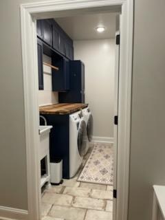 washroom featuring washer and dryer and baseboards