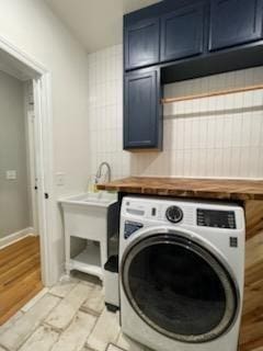 laundry room with washer / clothes dryer, cabinet space, and baseboards