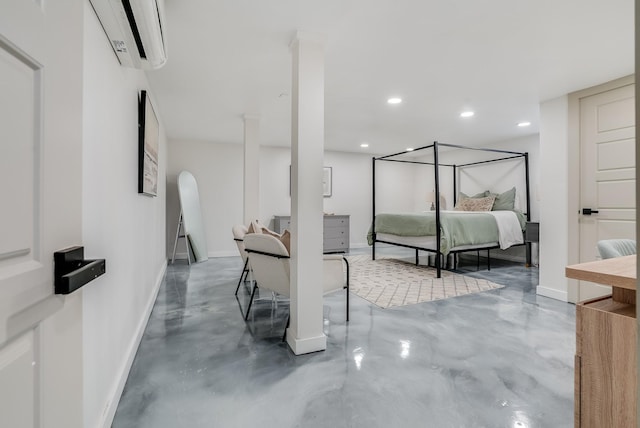 bedroom featuring finished concrete flooring, an AC wall unit, arched walkways, baseboards, and recessed lighting