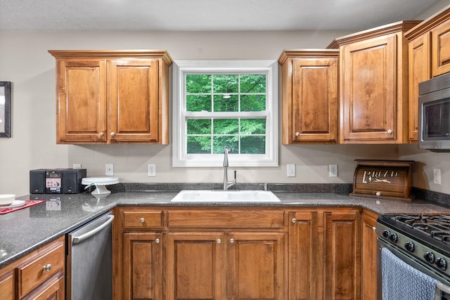 5643 Bethlehem Rd, Springfield, TN 37172 - kitchen with a sink, stainless steel appliances, dark countertops, and brown cabinetry