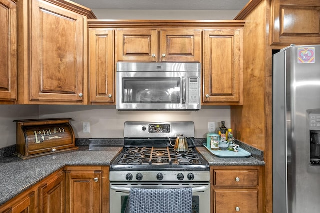 5643 Bethlehem Rd, Springfield, TN 37172 - kitchen with appliances with stainless steel finishes and brown cabinets