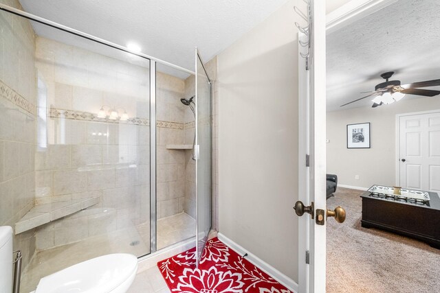5643 Bethlehem Rd, Springfield, TN 37172 - bathroom with a shower stall, toilet, a textured ceiling, baseboards, and a ceiling fan