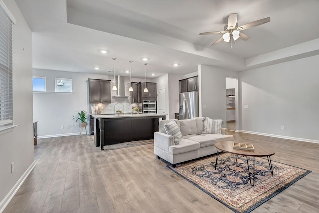 1044 Alta Vista Ln, Smyrna, TN 37167 - living room featuring a raised ceiling, baseboards, light wood-type flooring, and recessed lighting