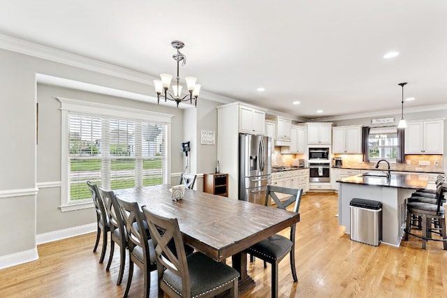 1384 Round Hill Ln, Spring Hill, TN 37174 - dining room featuring healthy amount of natural light, crown molding, a chandelier, recessed lighting, and light wood-type flooring
