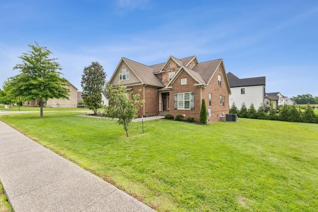 1384 Round Hill Ln, Spring Hill, TN 37174 - traditional home with brick siding, a front yard, and cooling unit