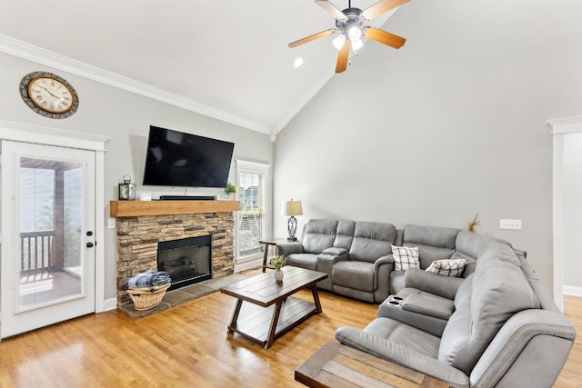 1384 Round Hill Ln, Spring Hill, TN 37174 - living room featuring a stone fireplace, crown molding, ceiling fan, light wood finished floors, and high vaulted ceiling