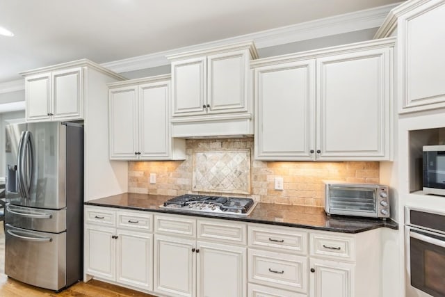 1384 Round Hill Ln, Spring Hill, TN 37174 - kitchen featuring stainless steel appliances, ornamental molding, tasteful backsplash, and dark stone counters