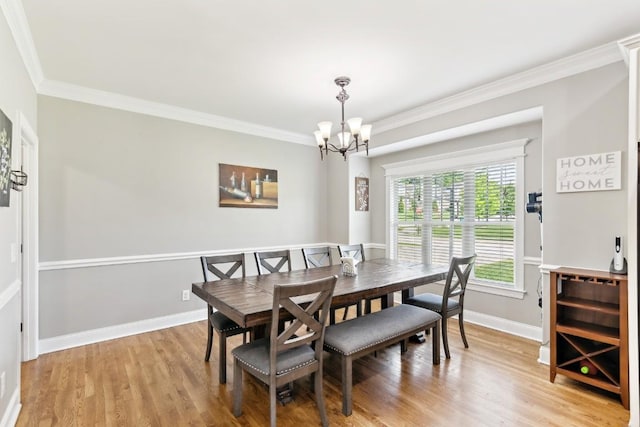1384 Round Hill Ln, Spring Hill, TN 37174 - dining room with a chandelier, light wood-style floors, crown molding, and baseboards