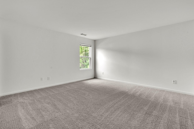 carpeted empty room with baseboards