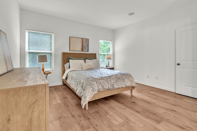 bedroom featuring light wood-style floors and baseboards