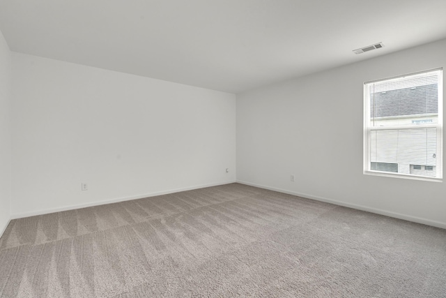 empty room with carpet floors and baseboards